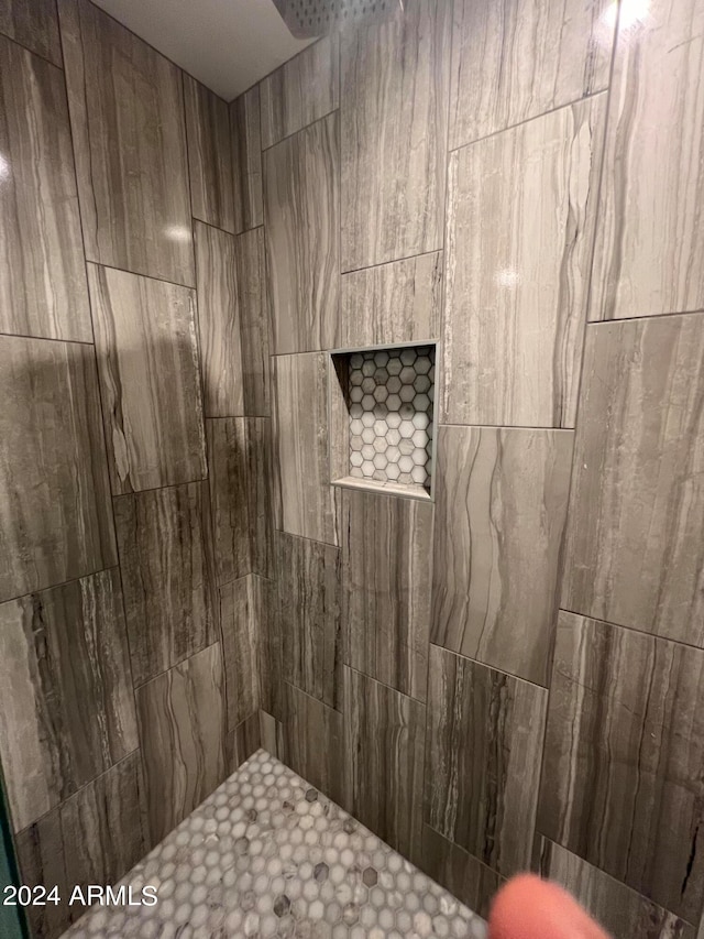 bathroom with a tile shower