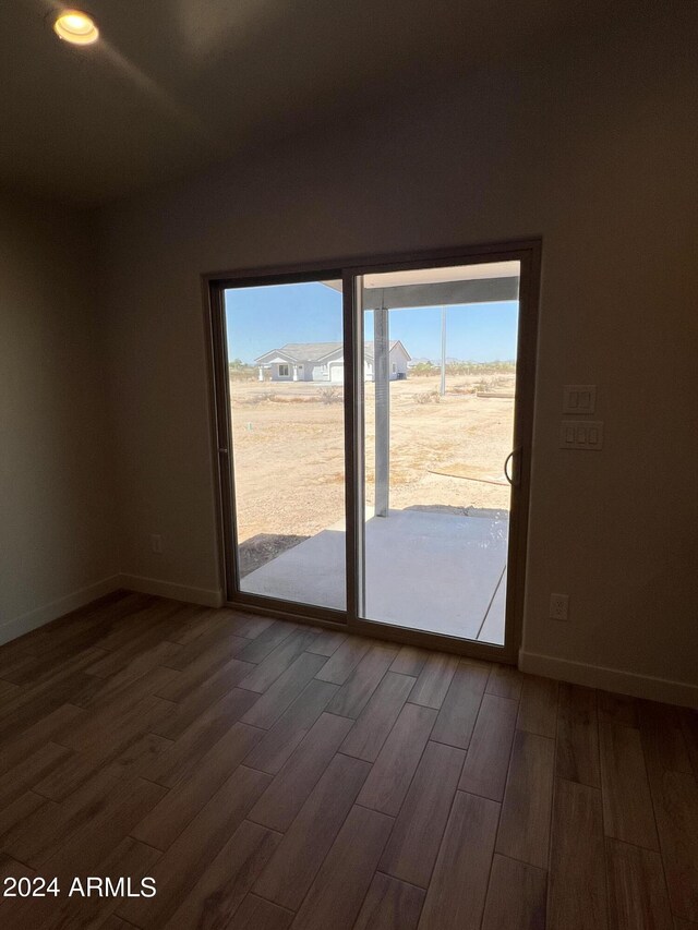 spare room featuring ceiling fan and dark hardwood / wood-style floors