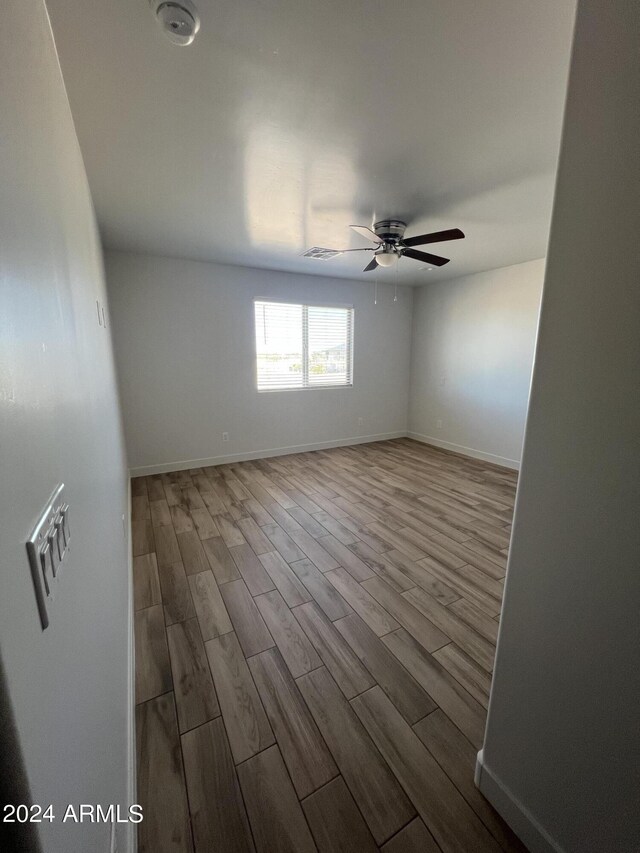 bathroom featuring walk in shower, toilet, and wood-type flooring