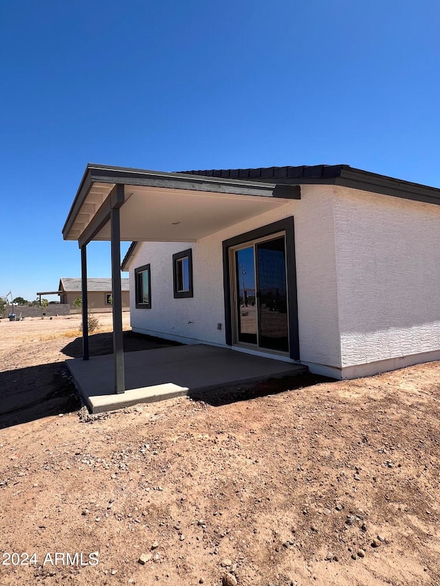 rear view of property featuring a patio area