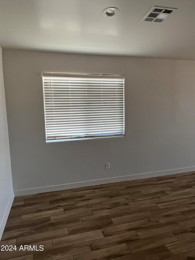 empty room with dark wood-type flooring