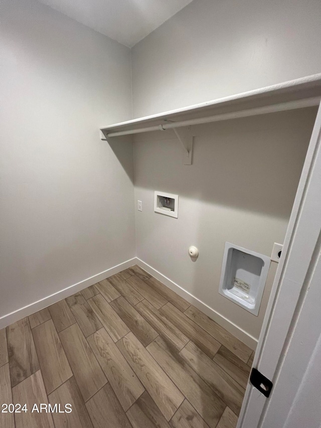 laundry room with wood-type flooring, hookup for a gas dryer, and hookup for a washing machine