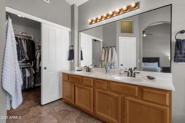 20239 N 39th Dr, Glendale, AZ 85308 - ensuite bathroom featuring double vanity, a ceiling fan, tile patterned flooring, and a walk in closet