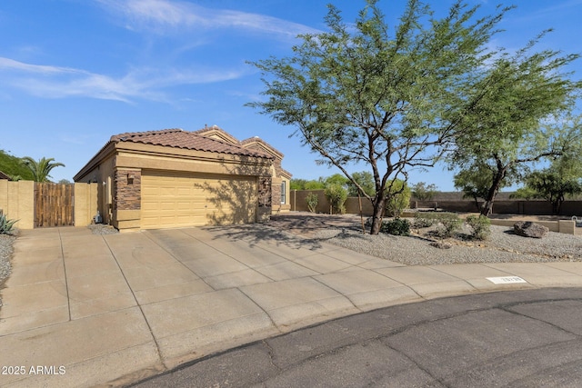 20239 N 39th Dr, Glendale, AZ 85308 - view of front of house featuring a garage, driveway, a tiled roof, a gate, and stucco siding