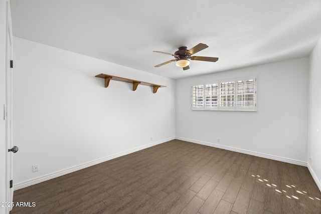 empty room featuring ceiling fan and dark hardwood / wood-style flooring