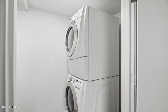 clothes washing area with stacked washer and dryer