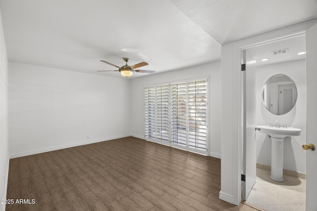 interior space featuring a textured ceiling, ceiling fan, and light wood-type flooring