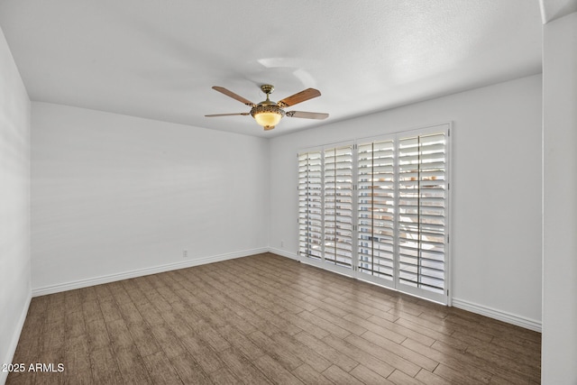 spare room with hardwood / wood-style flooring, a textured ceiling, and ceiling fan