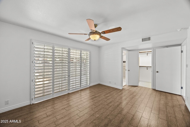 unfurnished room with light hardwood / wood-style flooring and ceiling fan