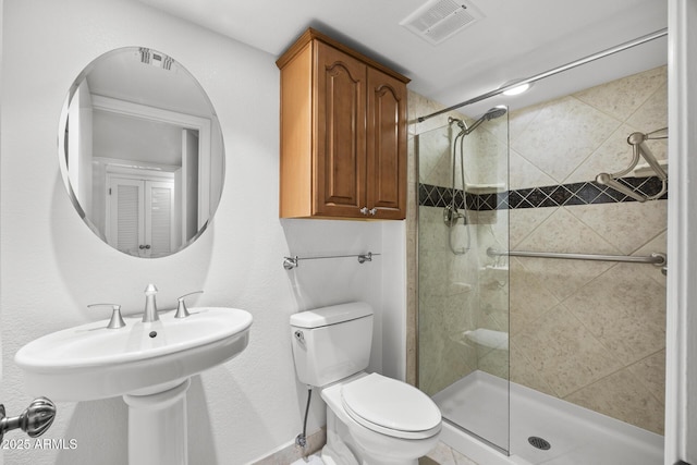 bathroom with an enclosed shower and toilet