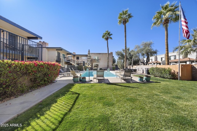 view of community with a yard and a patio area