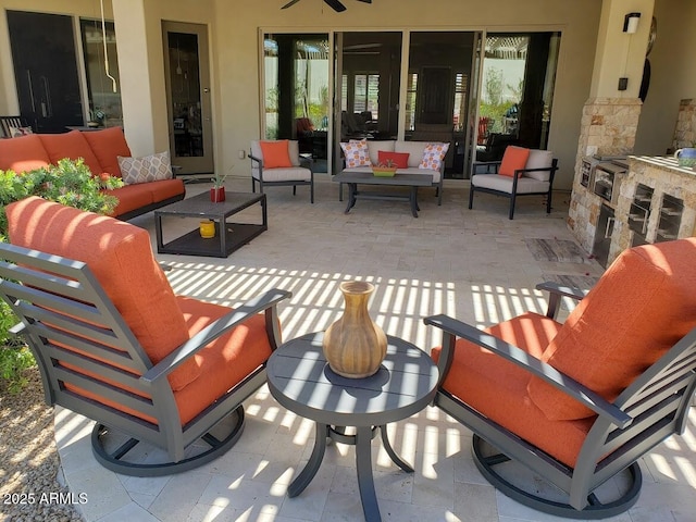 view of patio / terrace with an outdoor living space and ceiling fan