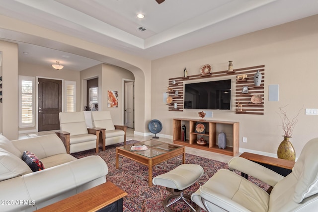 living room with a tray ceiling