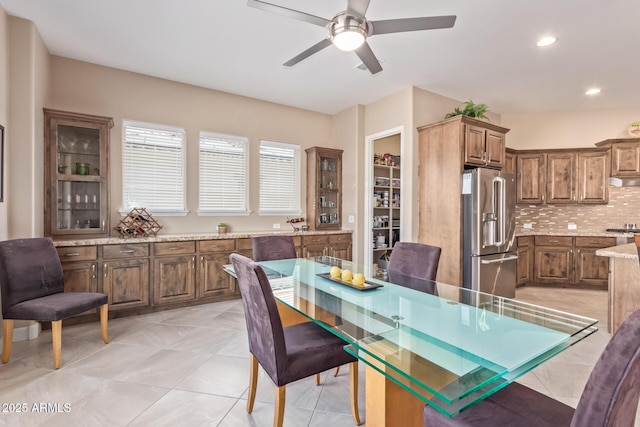 dining space with light tile patterned floors and ceiling fan