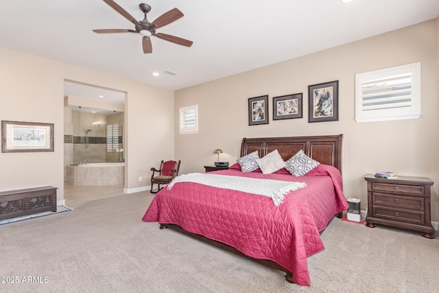 bedroom featuring ceiling fan, light colored carpet, and ensuite bathroom