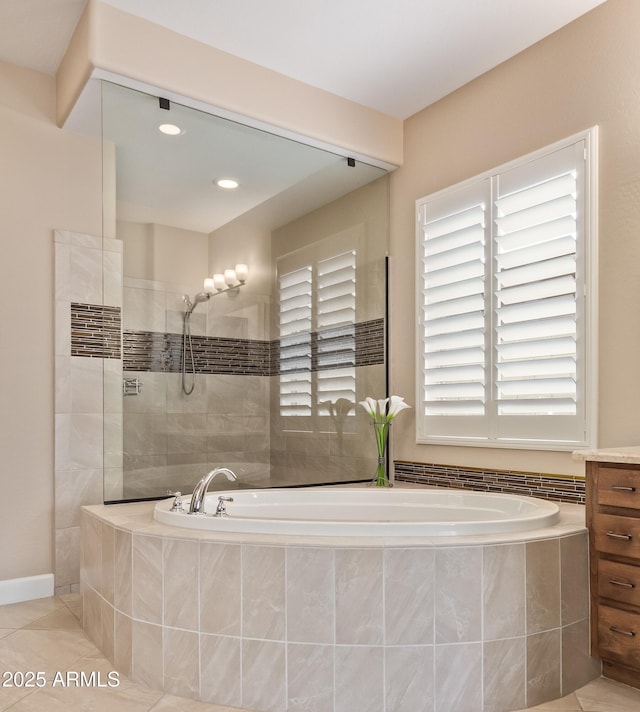 bathroom with tile patterned floors and independent shower and bath