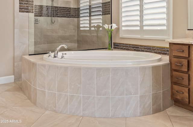 bathroom with independent shower and bath, vanity, and tile patterned floors