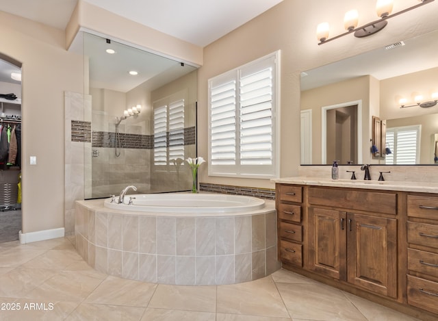 bathroom featuring vanity, tile patterned floors, and separate shower and tub