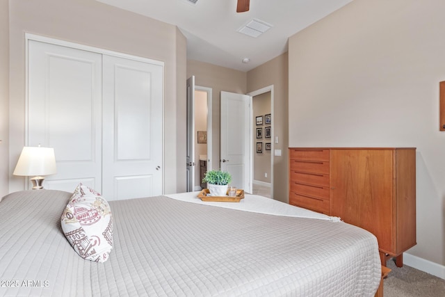 carpeted bedroom featuring ceiling fan and a closet