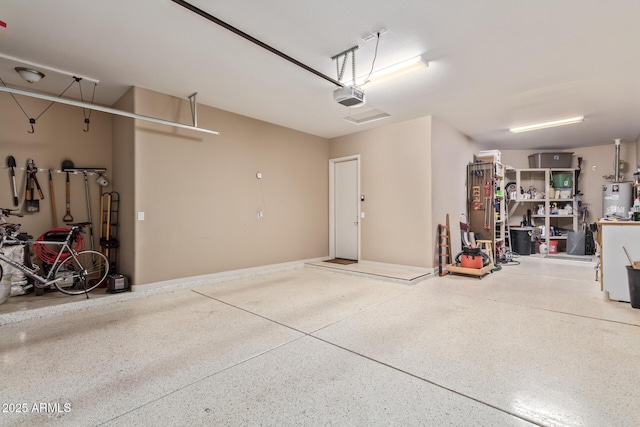 garage with a garage door opener and water heater