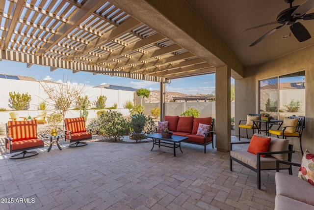 view of patio / terrace featuring ceiling fan, an outdoor living space, and a pergola