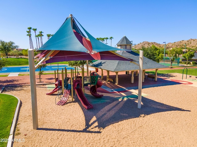 view of playground featuring a mountain view