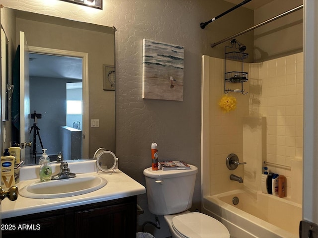 6538 W Nez Perce St, Phoenix, AZ 85043 - full bathroom featuring a textured wall, toilet, vanity, and tub / shower combination