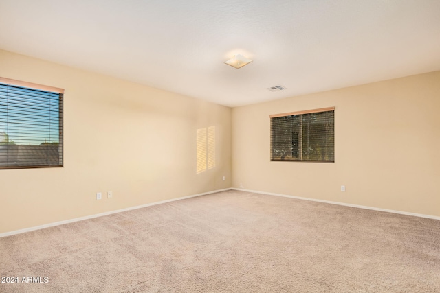 unfurnished room featuring carpet