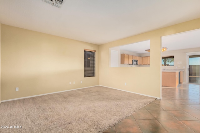 spare room featuring light colored carpet