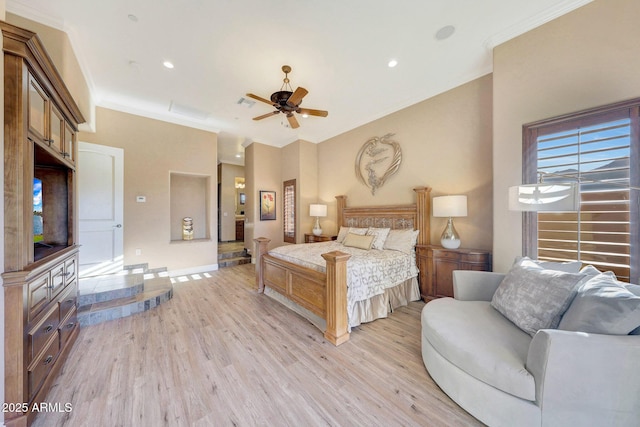 bedroom featuring light wood-type flooring, ceiling fan, and crown molding