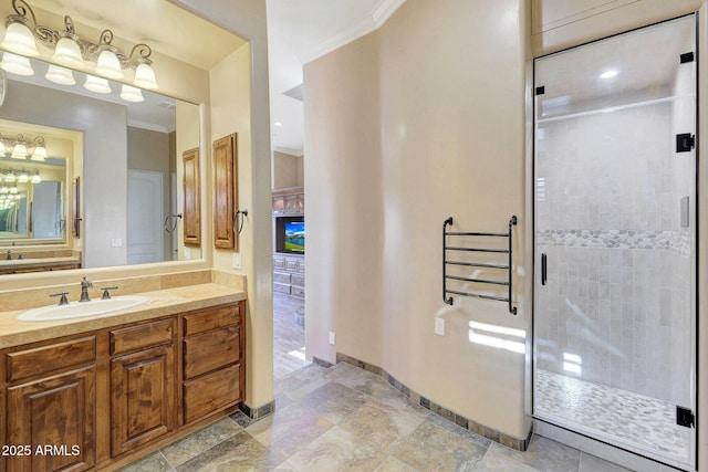 bathroom with vanity, an enclosed shower, and ornamental molding