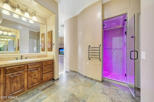 bathroom featuring vanity, crown molding, and a shower with shower door