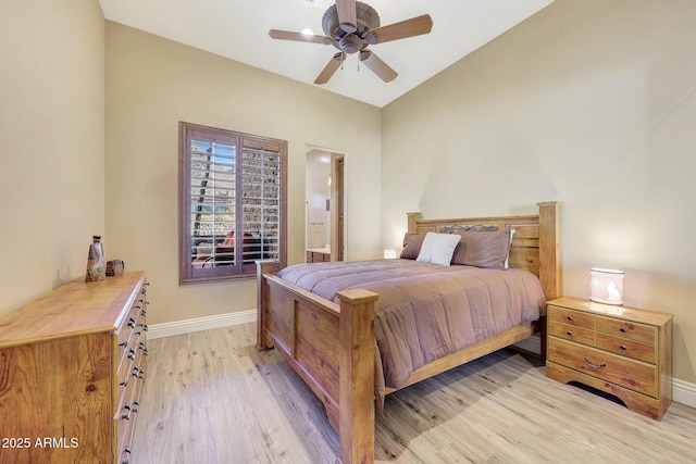 bedroom with ceiling fan, light hardwood / wood-style floors, and lofted ceiling