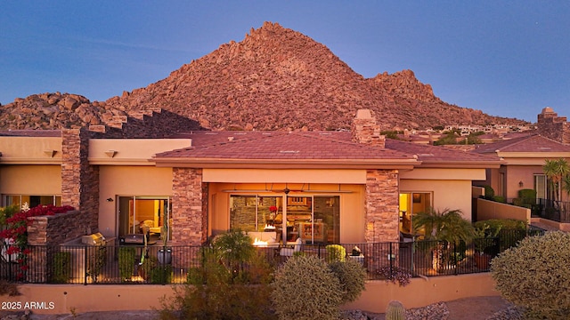 back house at dusk featuring a mountain view