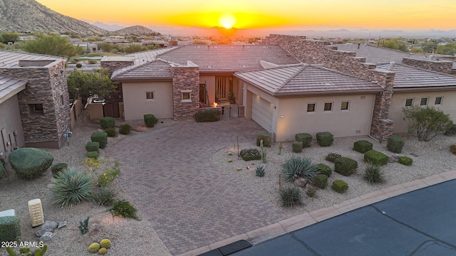 view of front of property featuring a mountain view and a garage