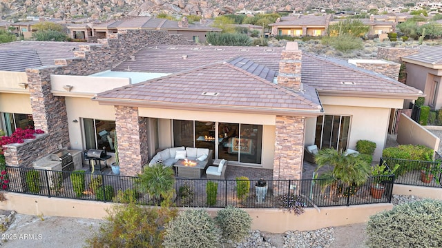 back of house featuring an outdoor living space and a patio