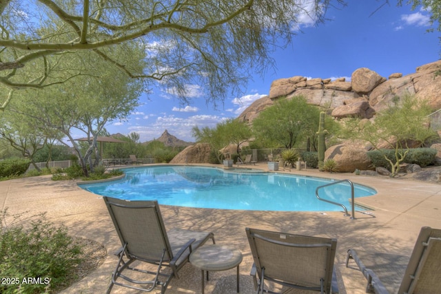 view of pool with a mountain view and a patio