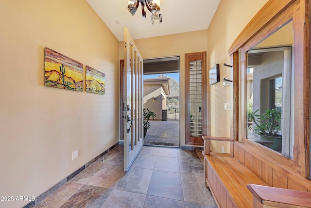 entrance foyer featuring a wealth of natural light and a chandelier