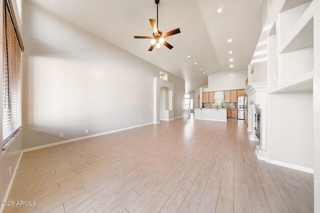 10253 E Indigo Dr, Scottsdale, AZ 85255 - unfurnished living room with a ceiling fan, high vaulted ceiling, light wood finished floors, recessed lighting, and baseboards
