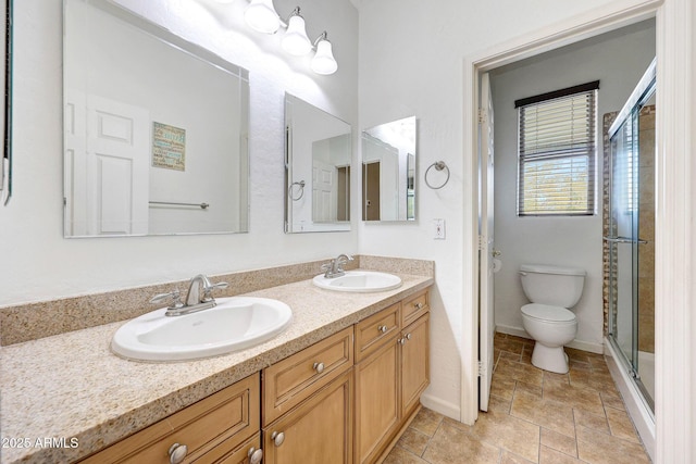 10253 E Indigo Dr, Scottsdale, AZ 85255 - bathroom featuring toilet, double vanity, a stall shower, and baseboards