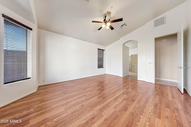 10253 E Indigo Dr, Scottsdale, AZ 85255 - unfurnished room featuring arched walkways, lofted ceiling, a ceiling fan, light wood finished floors, and baseboards