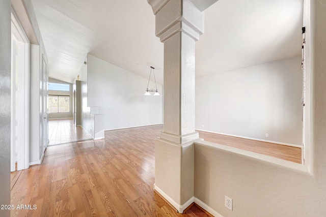 10253 E Indigo Dr, Scottsdale, AZ 85255 - corridor with decorative columns, wood finished floors, lofted ceiling, and baseboards