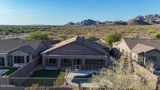 10253 E Indigo Dr, Scottsdale, AZ 85255 - view of front of home featuring a fenced backyard, a patio area, a mountain view, and stucco siding
