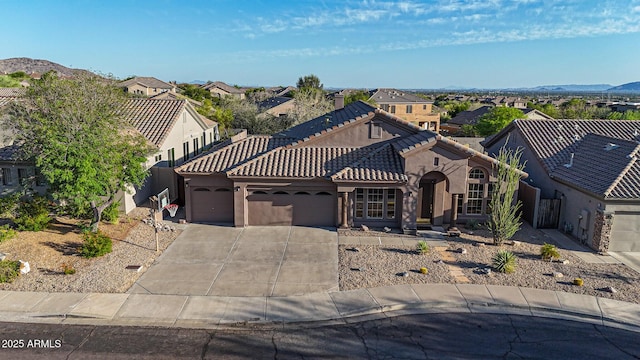 10253 E Indigo Dr, Scottsdale, AZ 85255 - mediterranean / spanish house featuring an attached garage, a residential view, concrete driveway, stucco siding, and a tile roof
