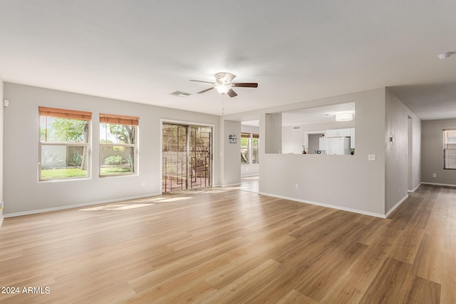 unfurnished living room featuring ceiling fan and light hardwood / wood-style flooring