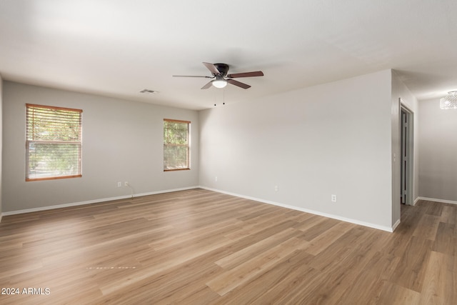 unfurnished room featuring ceiling fan and light hardwood / wood-style flooring