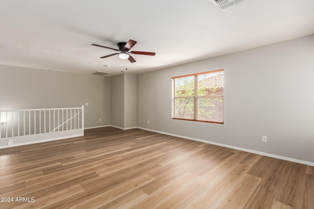 empty room with ceiling fan and hardwood / wood-style flooring