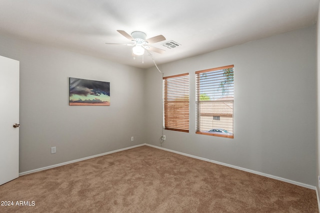 empty room with ceiling fan and carpet flooring