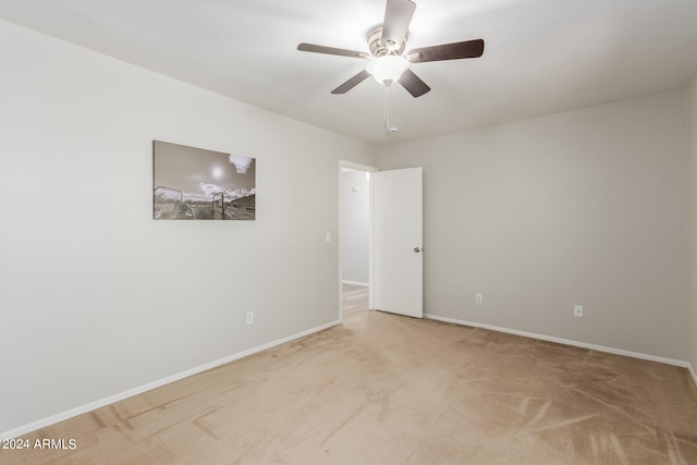 carpeted spare room with ceiling fan