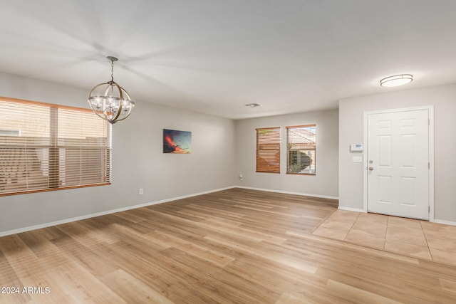 interior space featuring an inviting chandelier and light hardwood / wood-style floors